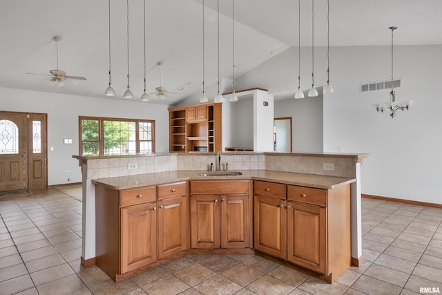 922 W Scott St, Eldridge, IA 52748 - kitchen featuring ceiling fan, backsplash, light stone countertops, a center island with sink, and open floor plan