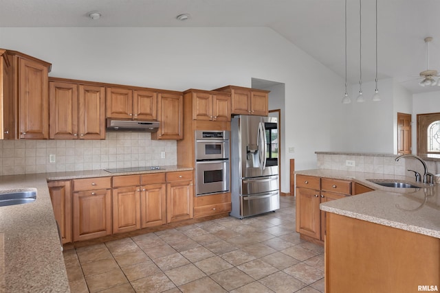922 W Scott St, Eldridge, IA 52748 - kitchen with appliances with stainless steel finishes, under cabinet range hood, tasteful backsplash, brown cabinets, and high vaulted ceiling