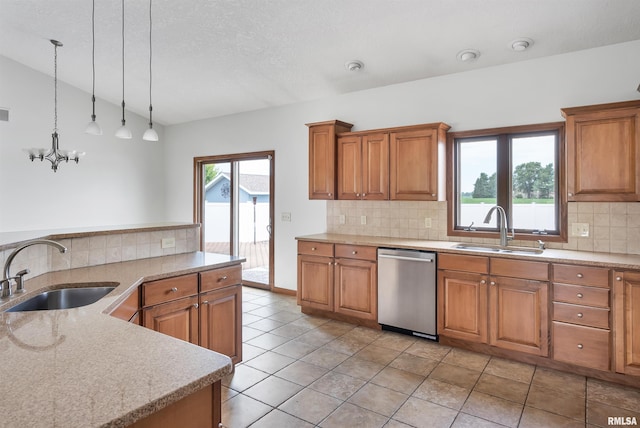 922 W Scott St, Eldridge, IA 52748 - kitchen featuring stainless steel dishwasher, vaulted ceiling, brown cabinetry, decorative backsplash, and hanging light fixtures