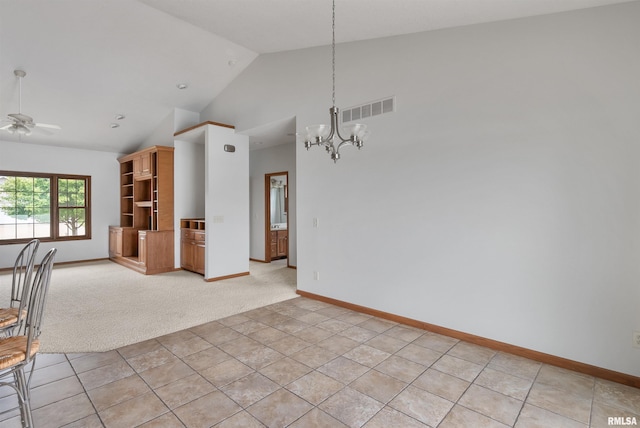 922 W Scott St, Eldridge, IA 52748 - unfurnished dining area with a chandelier, ceiling fan, light colored carpet, and high vaulted ceiling