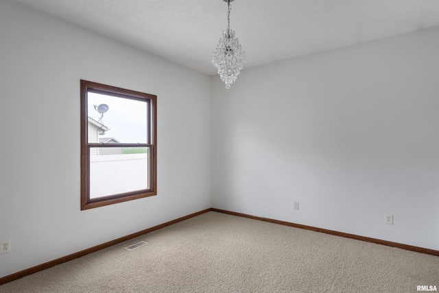 922 W Scott St, Eldridge, IA 52748 - carpeted empty room featuring a chandelier and baseboards