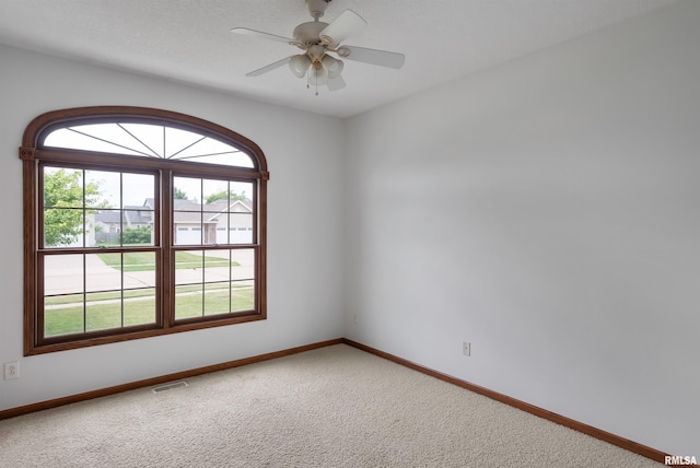 922 W Scott St, Eldridge, IA 52748 - carpeted spare room with baseboards and a ceiling fan