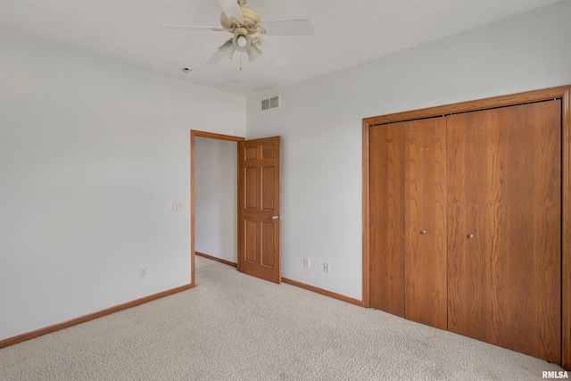 922 W Scott St, Eldridge, IA 52748 - unfurnished bedroom with carpet, a closet, and a ceiling fan