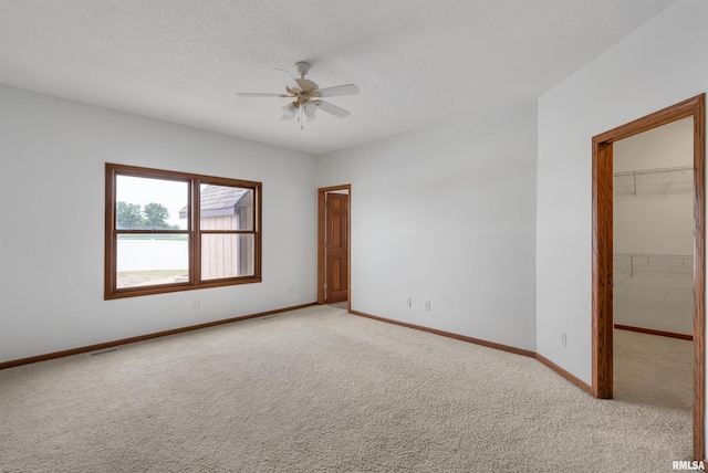 922 W Scott St, Eldridge, IA 52748 - spare room featuring light colored carpet and a ceiling fan