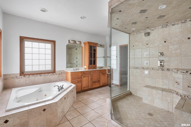 922 W Scott St, Eldridge, IA 52748 - full bath featuring double vanity, a jetted tub, a shower stall, tile patterned floors, and recessed lighting