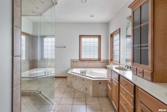 922 W Scott St, Eldridge, IA 52748 - bathroom with a garden tub, vanity, tile patterned flooring, and a textured ceiling