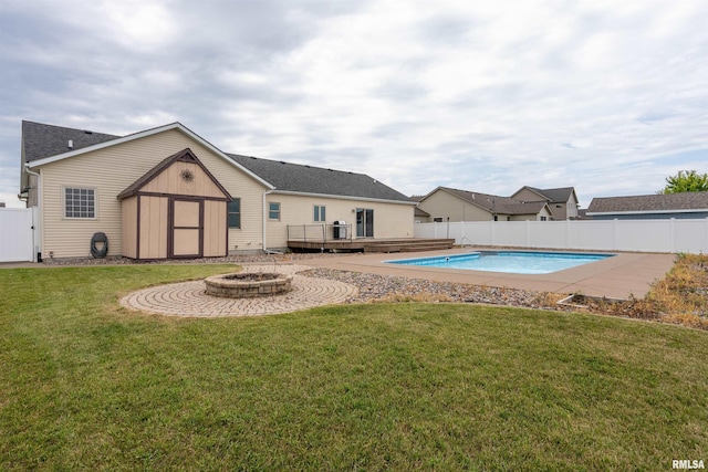 922 W Scott St, Eldridge, IA 52748 - view of pool with a fire pit, a wooden deck, a fenced backyard, a storage unit, and grilling area