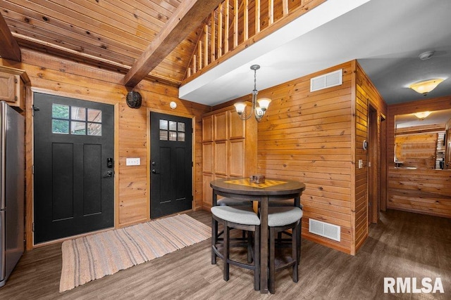 7319 106th Ave, Coal Valley, IL 61240 - dining space with wood walls, wood finished floors, and a chandelier