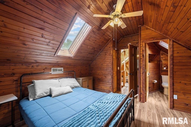 7319 106th Ave, Coal Valley, IL 61240 - bedroom featuring wood walls, vaulted ceiling, wood finished floors, wood ceiling, and a skylight