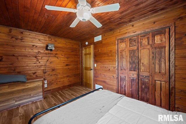 7319 106th Ave, Coal Valley, IL 61240 - unfurnished bedroom featuring wooden walls, a ceiling fan, wood ceiling, and wood finished floors