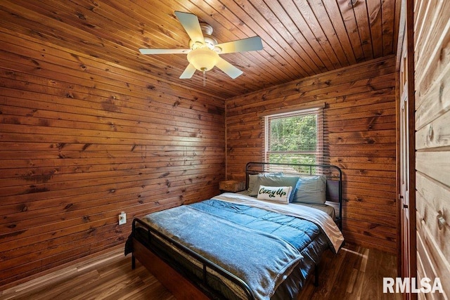 7319 106th Ave, Coal Valley, IL 61240 - bedroom featuring wood ceiling, wood walls, wood finished floors, and ceiling fan