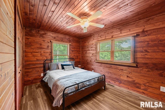 7319 106th Ave, Coal Valley, IL 61240 - bedroom featuring wooden ceiling, wood walls, wood finished floors, and ceiling fan