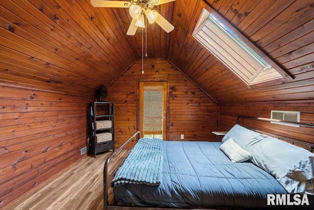 7319 106th Ave, Coal Valley, IL 61240 - bedroom featuring wood ceiling, wooden walls, lofted ceiling, wood finished floors, and a skylight