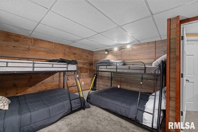 7319 106th Ave, Coal Valley, IL 61240 - bedroom featuring carpet flooring, wood walls, and a paneled ceiling