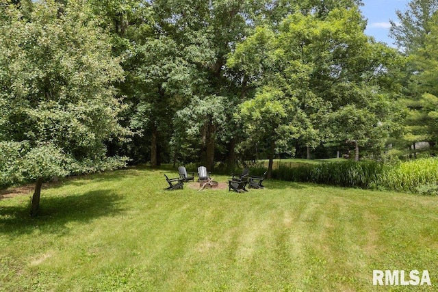 7319 106th Ave, Coal Valley, IL 61240 - view of green lawn with an outdoor fire pit