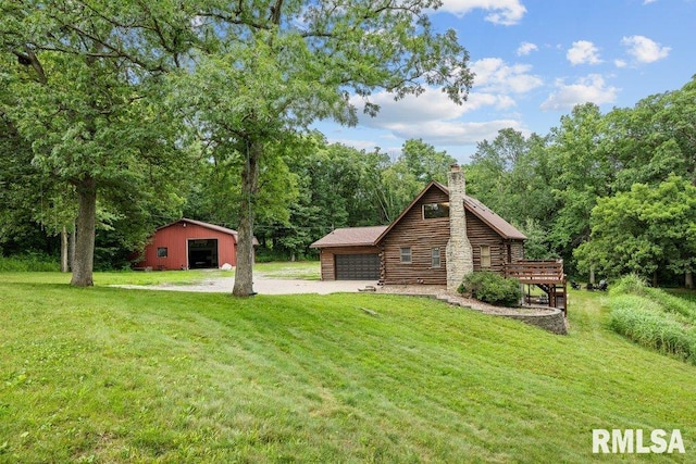 7319 106th Ave, Coal Valley, IL 61240 - view of front of property featuring a front lawn, a chimney, log exterior, a garage, and an outbuilding