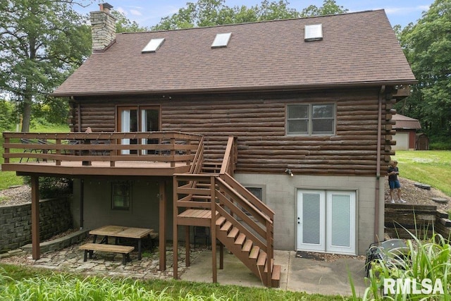 7319 106th Ave, Coal Valley, IL 61240 - rear view of house featuring log exterior, a wooden deck, a chimney, a patio, and stairs