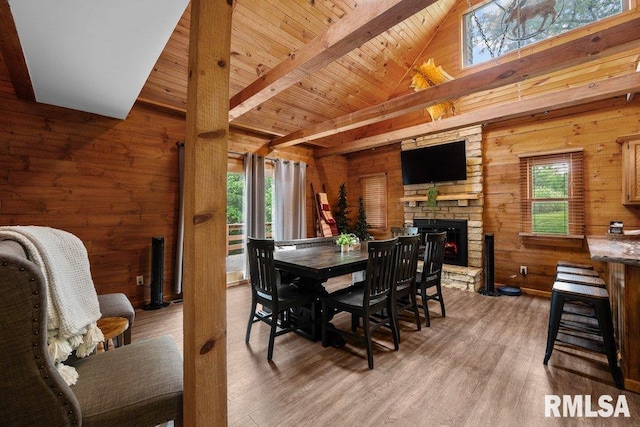 7319 106th Ave, Coal Valley, IL 61240 - dining room with wood walls, an outdoor stone fireplace, plenty of natural light, light wood-type flooring, and wooden ceiling