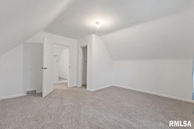 3916 W Locust St, Davenport, IA 52804 - additional living space featuring vaulted ceiling and carpet flooring
