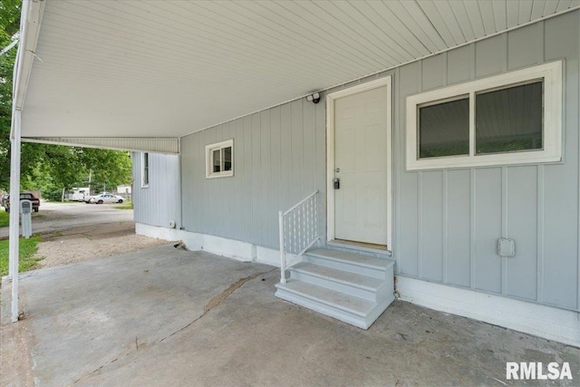 3916 W Locust St, Davenport, IA 52804 - property entrance featuring an attached carport and board and batten siding