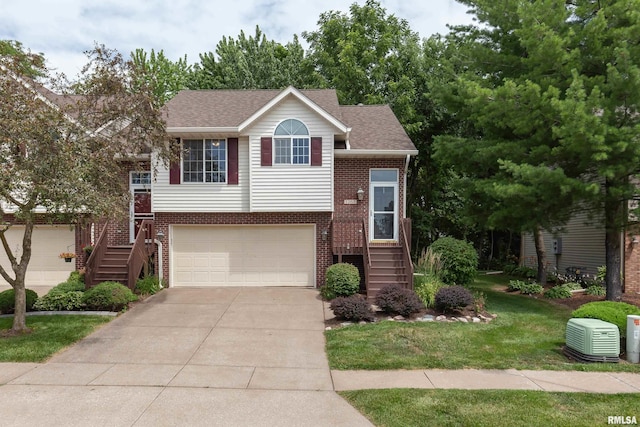 1263 33rd Avenue Cir, Silvis, IL 61282 - raised ranch with brick siding, stairway, driveway, an attached garage, and a front yard