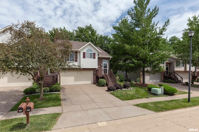 1263 33rd Avenue Cir, Silvis, IL 61282 - view of front facade with stairs, brick siding, concrete driveway, and an attached garage