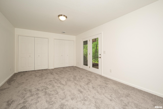 1263 33rd Avenue Cir, Silvis, IL 61282 - unfurnished bedroom featuring multiple closets, carpet, and access to outside