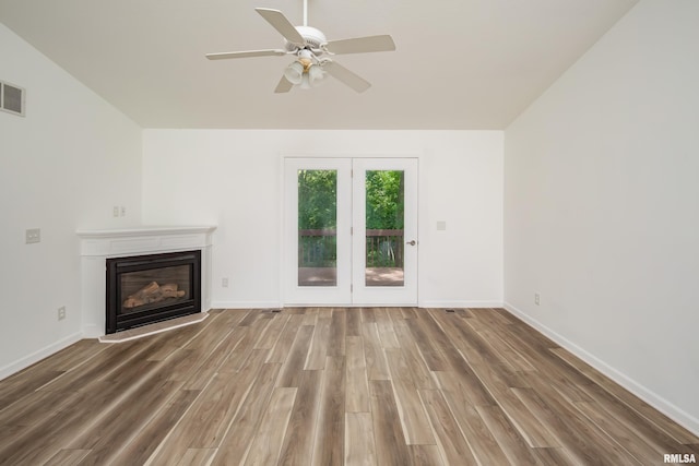1263 33rd Avenue Cir, Silvis, IL 61282 - unfurnished living room featuring wood finished floors, ceiling fan, and a glass covered fireplace