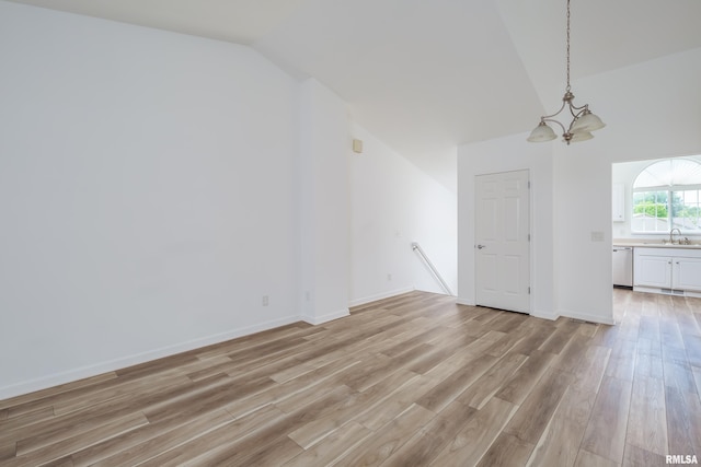 1263 33rd Avenue Cir, Silvis, IL 61282 - unfurnished living room featuring a chandelier, lofted ceiling, and light wood finished floors