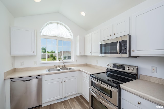 1263 33rd Avenue Cir, Silvis, IL 61282 - kitchen with stainless steel appliances, lofted ceiling, white cabinetry, light wood-type flooring, and light countertops