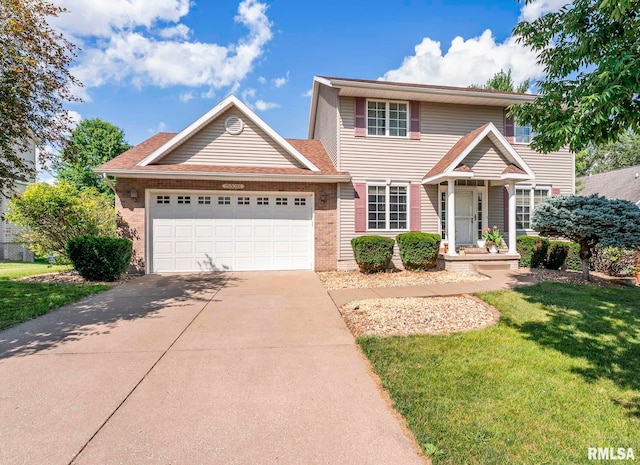 5320 Appleton Dr, Davenport, IA 52804 - traditional home featuring concrete driveway, an attached garage, a front lawn, and brick siding
