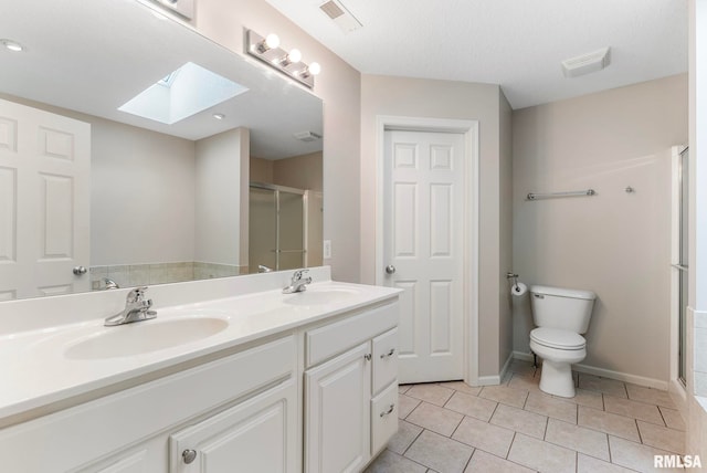5320 Appleton Dr, Davenport, IA 52804 - bathroom featuring a skylight, a shower stall, double vanity, and tile patterned flooring