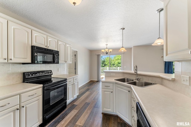5320 Appleton Dr, Davenport, IA 52804 - kitchen featuring black appliances, dark wood-style flooring, a chandelier, light countertops, and a textured ceiling