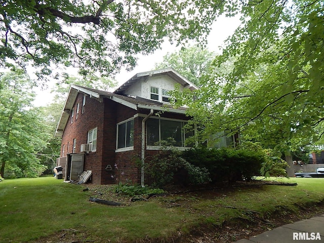1132 24th Ave, Moline, IL 61265 - view of home's exterior featuring a yard, brick siding, a sunroom, and cooling unit