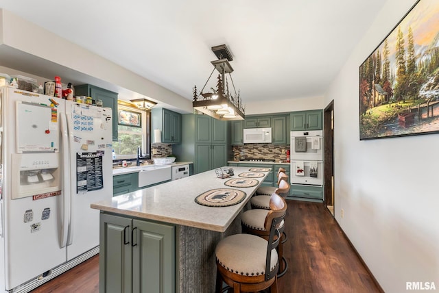 25622 1st Ave N, Hillsdale, IL 61257 - kitchen featuring white appliances, green cabinets, tasteful backsplash, dark wood finished floors, and a kitchen breakfast bar