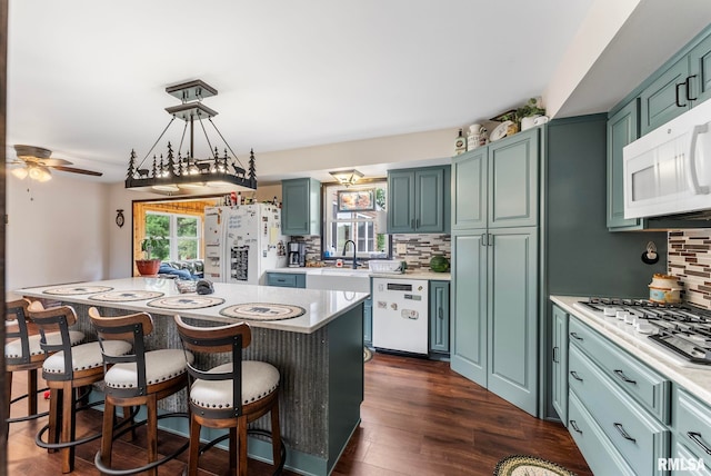 25622 1st Ave N, Hillsdale, IL 61257 - kitchen featuring white appliances, decorative backsplash, light countertops, and a ceiling fan
