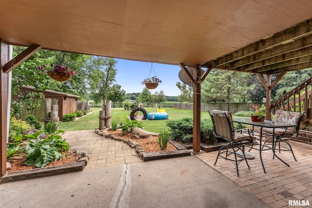 25622 1st Ave N, Hillsdale, IL 61257 - fenced backyard featuring a patio and outdoor dining area