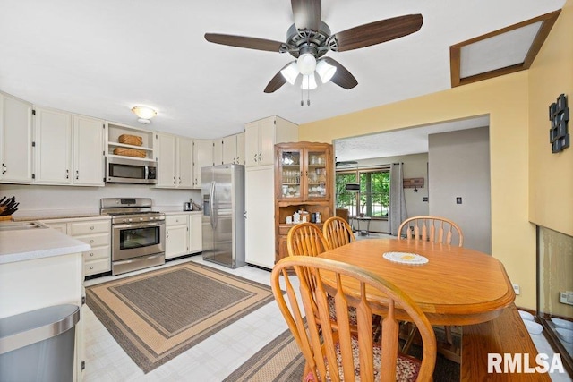 14325 139th Avenue Ct W, Taylor Ridge, IL 61284 - kitchen featuring stainless steel appliances, light countertops, ceiling fan, open shelves, and white cabinets