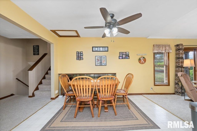 14325 139th Avenue Ct W, Taylor Ridge, IL 61284 - carpeted dining space featuring ceiling fan, stairs, and tile patterned floors