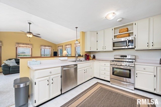 14325 139th Avenue Ct W, Taylor Ridge, IL 61284 - kitchen featuring appliances with stainless steel finishes, a peninsula, open floor plan, white cabinets, and vaulted ceiling