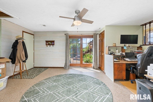 14325 139th Avenue Ct W, Taylor Ridge, IL 61284 - office space featuring healthy amount of natural light, wooden walls, a textured ceiling, ceiling fan, and light colored carpet