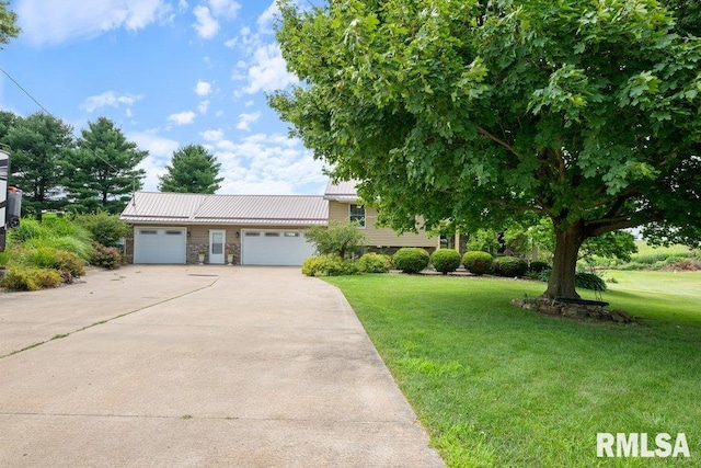 14325 139th Avenue Ct W, Taylor Ridge, IL 61284 - view of front of house featuring a garage, a front lawn, concrete driveway, stone siding, and a metal roof
