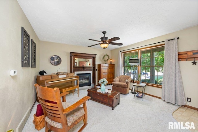 14325 139th Avenue Ct W, Taylor Ridge, IL 61284 - living room with a ceiling fan, a glass covered fireplace, light colored carpet, and a textured ceiling