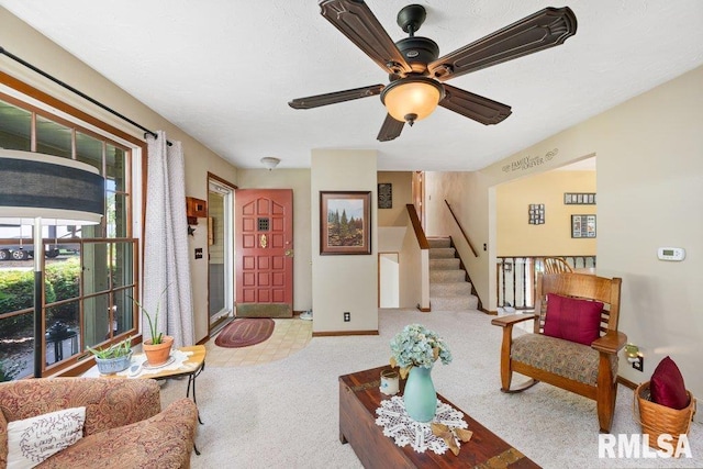14325 139th Avenue Ct W, Taylor Ridge, IL 61284 - carpeted living area with ceiling fan and stairway