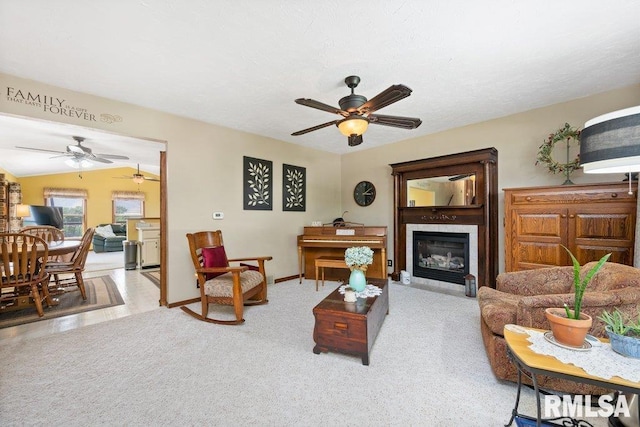 14325 139th Avenue Ct W, Taylor Ridge, IL 61284 - living area featuring a ceiling fan, a glass covered fireplace, and carpet flooring