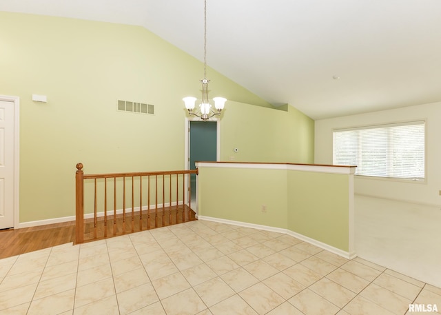 3439 Maple Glen Dr, Bettendorf, IA 52722 - spare room featuring a chandelier and high vaulted ceiling