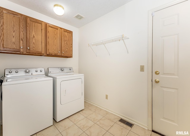 3439 Maple Glen Dr, Bettendorf, IA 52722 - laundry room with independent washer and dryer, cabinet space, and light tile patterned floors
