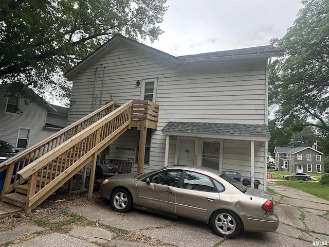 1328 E 9th St, Davenport, IA 52803 - view of front of property with a shingled roof and stairs