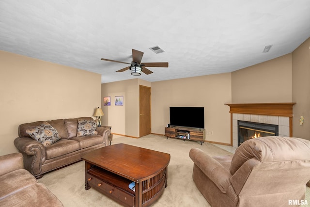 2809 12th Ave Unit 504, Rock Island, IL 61201 - living room featuring light colored carpet, a ceiling fan, and a tiled fireplace