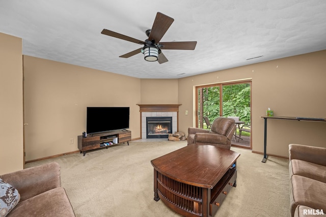 2809 12th Ave Unit 504, Rock Island, IL 61201 - living area featuring light carpet, a tiled fireplace, and a ceiling fan
